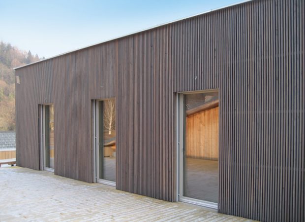 Aus unseren Referenzen: Beispiel für moderne Holzfassaden in Lärche vorvergraut